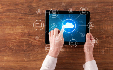 Hand touching tablet with cloud computing and online storage concept
