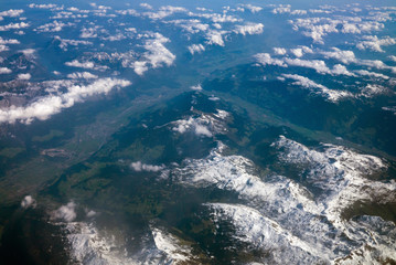Aerial view of Alps mountains with snow on mountain peaks seen from an airplane