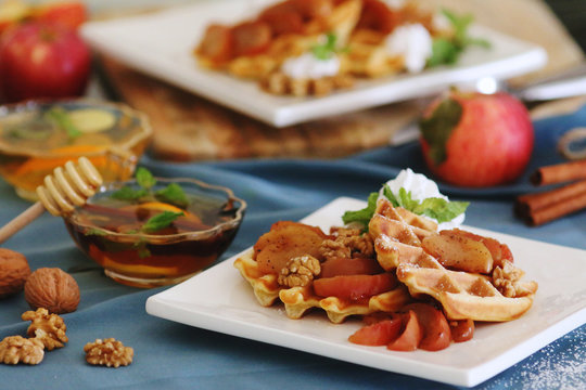 waffles sered with walnuts, honey and baked aples