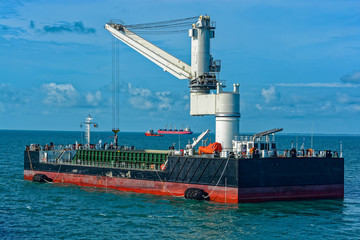 Floating Crane Transhipper with grab feeding system to cater to bauxite ore transhipment operations...