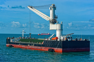 Floating Crane Transhipper with grab feeding system to cater to bauxite ore transhipment operations from barges at outer anchorage of Kamsar, Guinea.