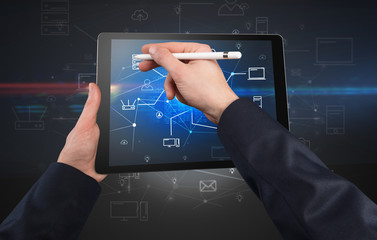 First person view of a hand using tablet with cloud office concept

