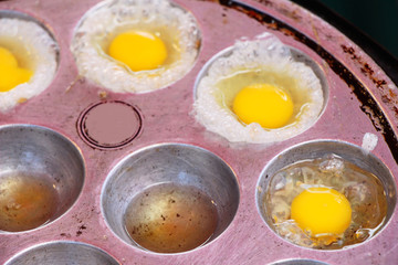 Grilled quail eggs in a pan pits