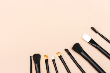 Set of makeup brushes isolated on pink background