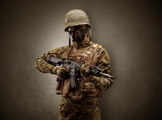 Soldier agent in a dark room with arms on his hand and gas mask
