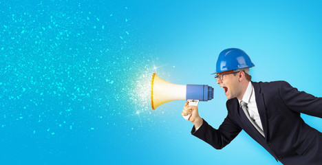 Fototapeta premium Young architect constructor yelling with megaphone and sparkling sounds 