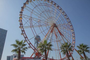 Ferris wheel on a bright sunny day in amusement park