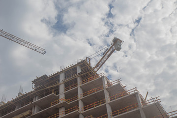 crane against sky building a new block of flats. new multi-storey house