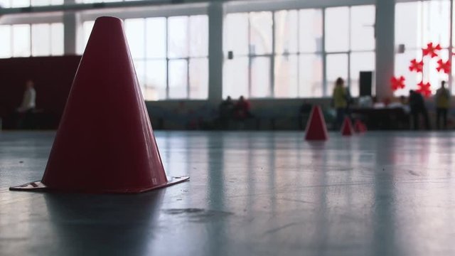red cones for the relay competitions on the floor in the sports hall in the school