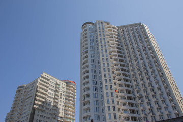 Fototapeta na wymiar Modern apartment buildings exteriors in sunny day. Skyscraper in Downtown city