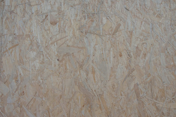 Wooden board Osb for background decoration. Pressed pieces of plant waste materials