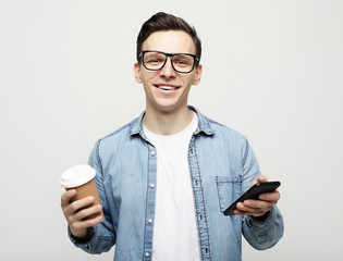  Portrait of happy man talking on phone and drinking coffee
