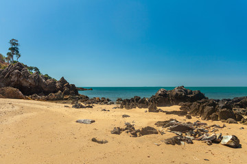 Fototapeta na wymiar Beautiful deserted tropical beach with rocks