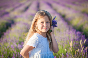 Girl with a bouquet in a lavender field