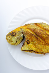 Fried fish on white background with selective focus and crop fragment