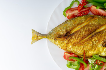 Fried fish on white background with selective focus and crop fragment