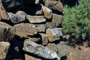 old ancient ruined stonework wall of bricks and stone blocks foreground closeup isolated on white background