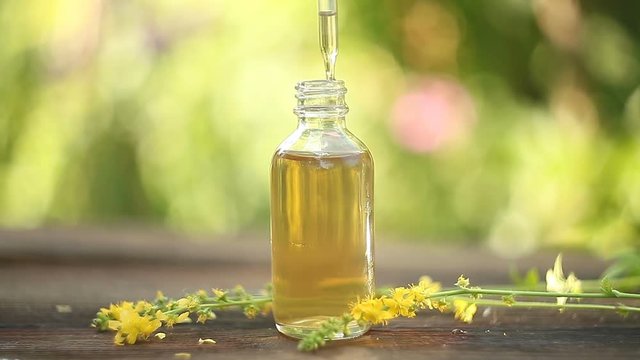 Essence of lavender flowers on table in beautiful glass Bottle