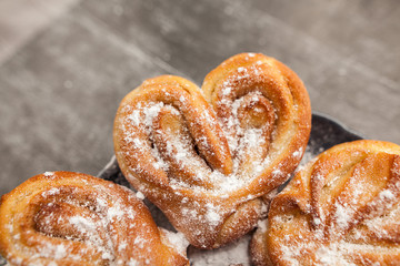 Rustic homemade heart shape bun on textured background