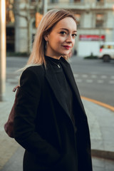 Corporate portrait of blonde girl in street