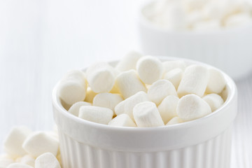 Fototapeta na wymiar White marshmallows in a bowl.