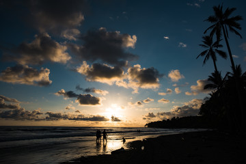 group of people enjoying sunset on the Uvita beach Costa Rica © Ji