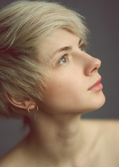 Fototapeta premium Thoughtful blond woman looking upward