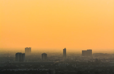 Air pollution of City with orange sky background,dust 2.5 Particulate Matte.