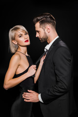 beautiful seductive couple hugging isolated on black