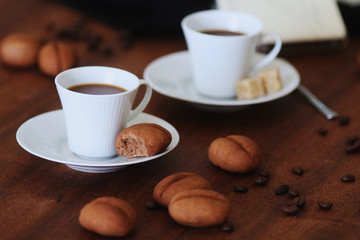 Sweet cookies shaped as cofee beans served with coffee cup