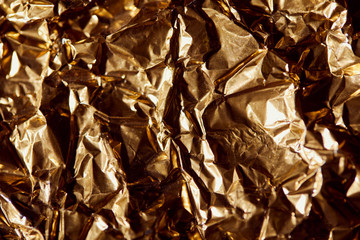 creased golden foil sheet with twinkles and shadows