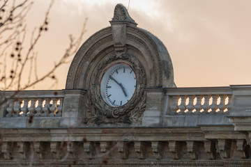 Clock on a building with marble walls