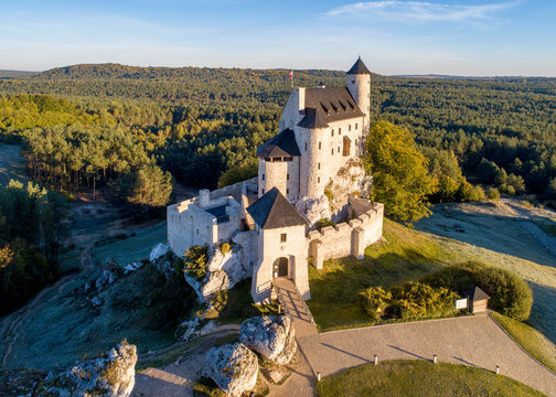 Medieval Castle in Bobolice, Poland, built in 14th century, renovated in 20th century. One of strongholds called Eagles Nests in Polish Jurassic Highland in Silesia. Aerial view in sunrise light