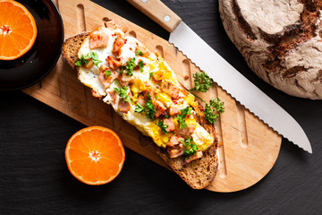Food concept organic french Sourdough toasted with eggs and ham on wooden cutting board