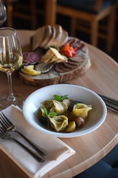 Bowl of dumpling soup and charcuterie board