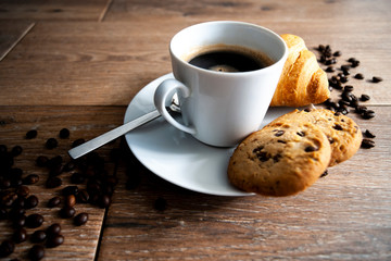 coffee in white mug with cookies and Croissant