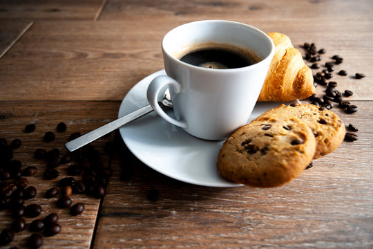 coffee in white mug with cookies and Croissant © Przemysaw