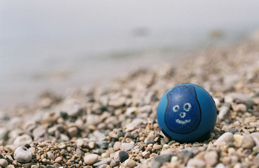 Ball with a face on the beach