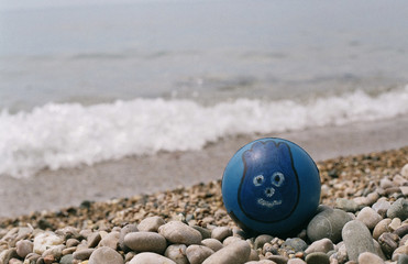 Ball with a face on the beach
