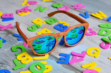 colored cutout letters with sunglasses