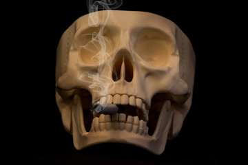 Human's skull smoking cigarette on black cackground