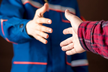 worker in blue uniform having a handshake with his customer b