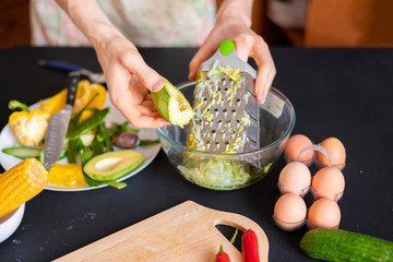 chef grating avocado at the kitchen b