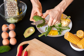 fresh green avocado cut in half with a chef b