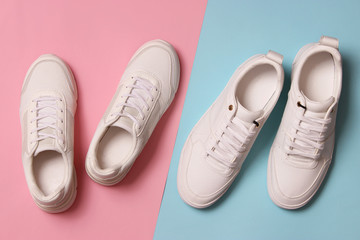  Men's and women's sneakers on a colored background top view. Sport shoes. White running shoes
