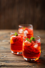 Fresh summer cocktail with ice, strawberry and mint