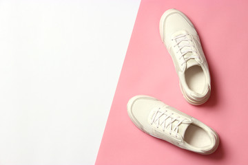 women's sneakers on a colored background top view. Women's shoes.
