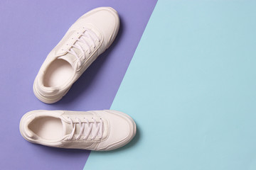 women's sneakers on a colored background top view. Women's shoes.
