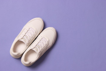 women's sneakers on a colored background top view. Women's shoes.