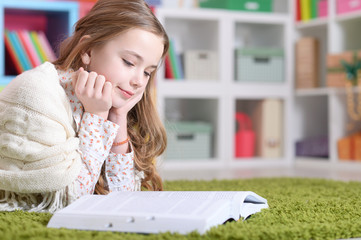 Portrait of cute happy girl studying at home